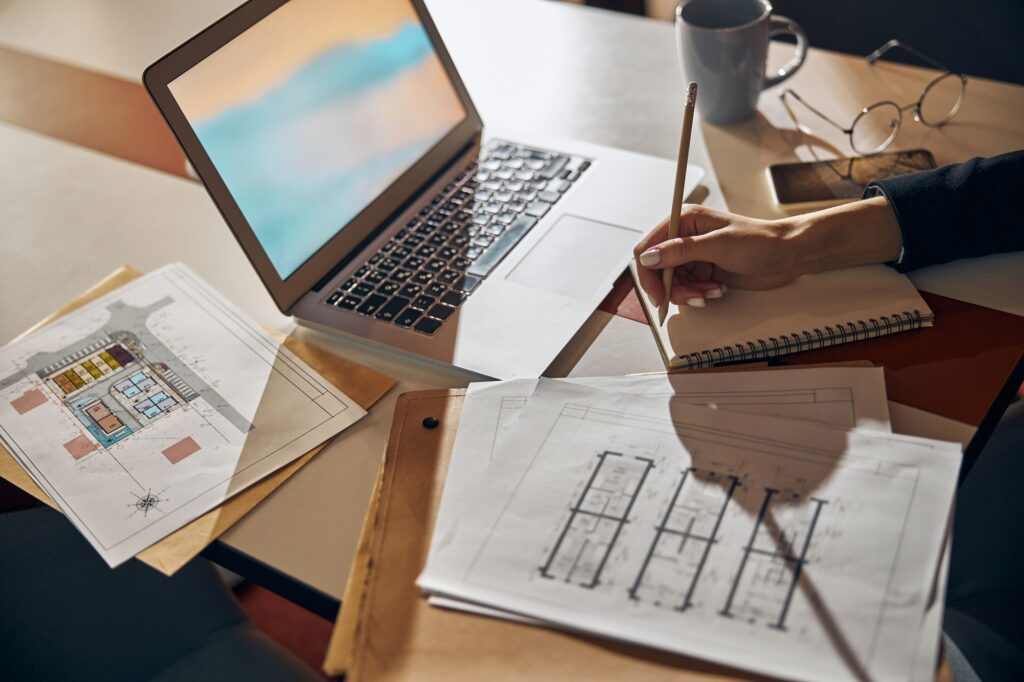Engineer taking notes with a pencil at the desk